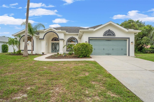 view of front of property with concrete driveway, a garage, a front lawn, and stucco siding