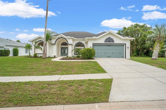 view of front of home featuring an attached garage, driveway, a front yard, and stucco siding