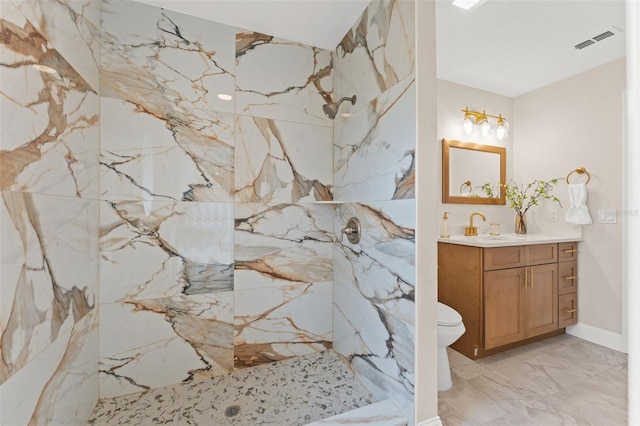 full bathroom with a marble finish shower, vanity, marble tiled floors, and toilet