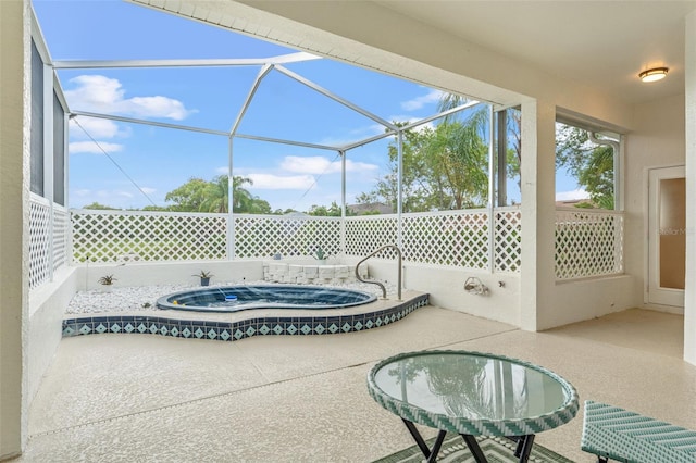 view of patio featuring an in-ground hot tub and glass enclosure
