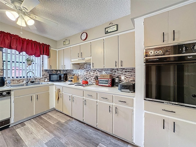 6213 Emerson Dr, New Port Richey, FL 34653 - kitchen featuring black appliances, under cabinet range hood, a sink, ceiling fan, and light countertops