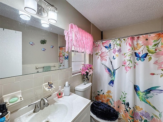 6213 Emerson Dr, New Port Richey, FL 34653 - full bathroom featuring toilet, vanity, curtained shower, tile walls, and a textured ceiling