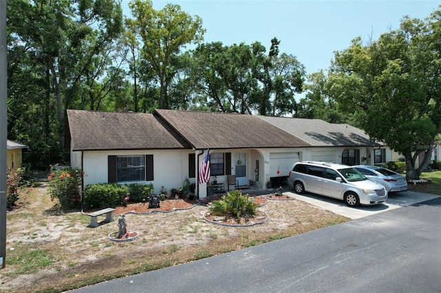 6213 Emerson Dr, New Port Richey, FL 34653 - single story home featuring a garage, concrete driveway, stucco siding, and a shingled roof