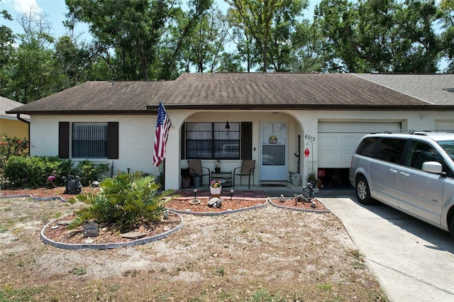 6213 Emerson Dr, New Port Richey, FL 34653 - ranch-style home featuring a garage, a porch, a shingled roof, stucco siding, and driveway