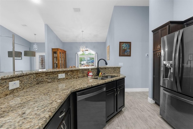 kitchen with black fridge with ice dispenser, stainless steel dishwasher, a sink, lofted ceiling, and light stone counters