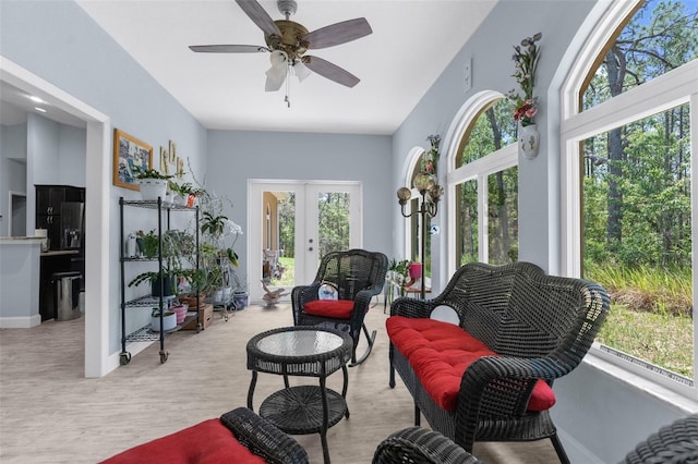 living area featuring french doors, a ceiling fan, wood finished floors, and baseboards