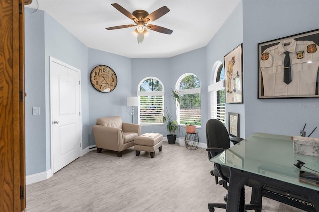 office area with wood finished floors, ceiling fan, and baseboards
