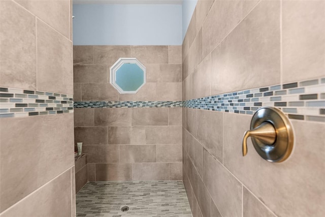 full bathroom with a tile shower