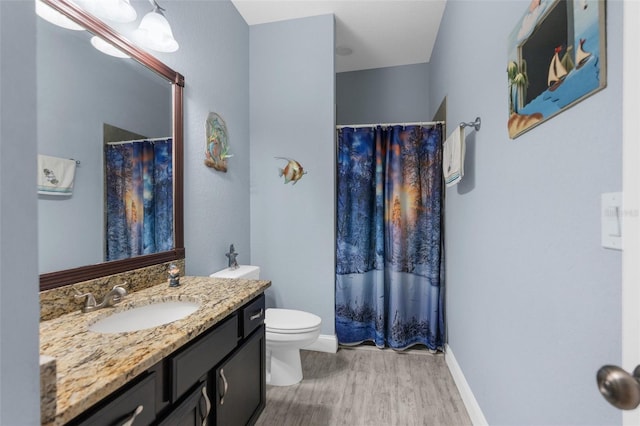 full bath featuring wood finished floors, baseboards, vanity, toilet, and a shower with shower curtain