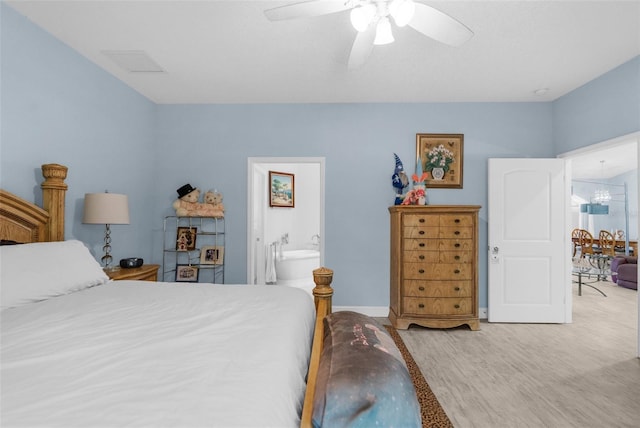 bedroom with wood finished floors, ceiling fan, baseboards, and connected bathroom