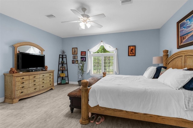 bedroom with wood finished floors, baseboards, and a ceiling fan