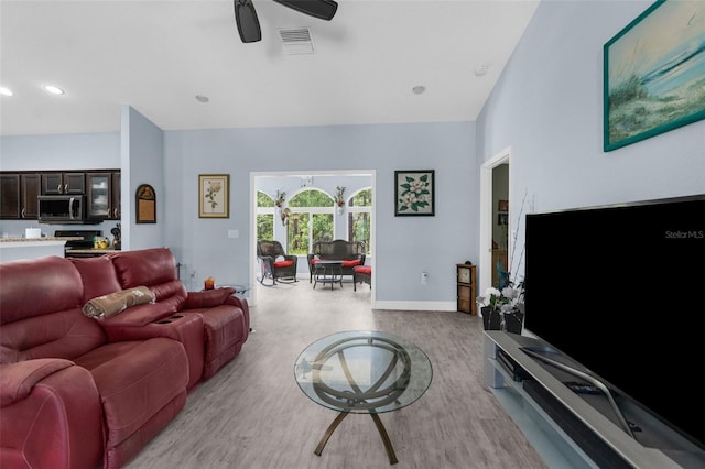living area featuring wood finished floors, a ceiling fan, baseboards, and recessed lighting
