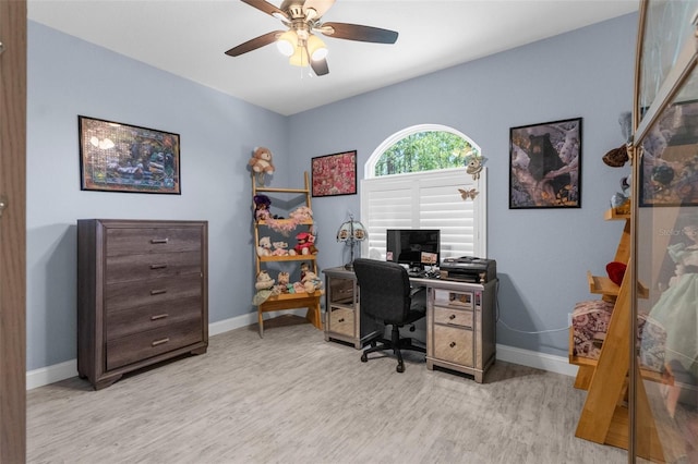 home office featuring baseboards, wood finished floors, and a ceiling fan