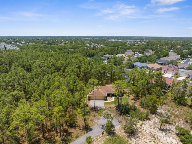 aerial overview of property's location with a heavily wooded area