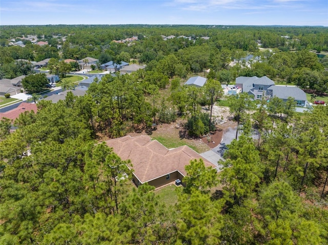 aerial view of residential area featuring a heavily wooded area