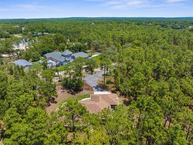 aerial overview of property's location with a heavily wooded area