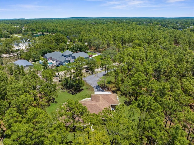 view of property location with a heavily wooded area