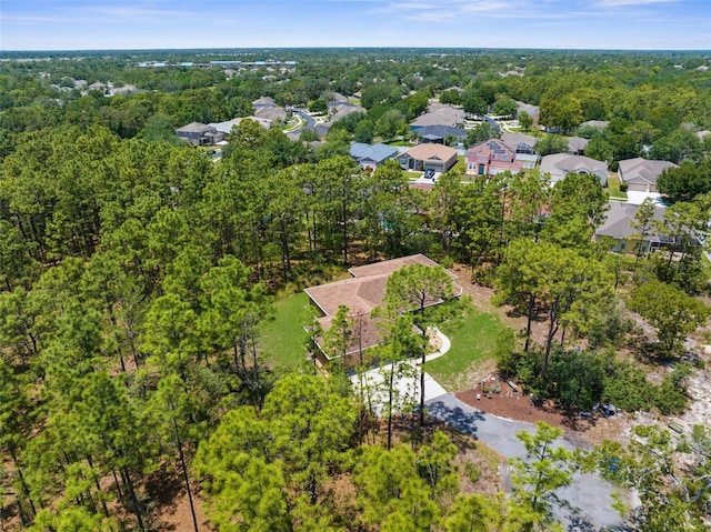 aerial overview of property's location with a forest and nearby suburban area