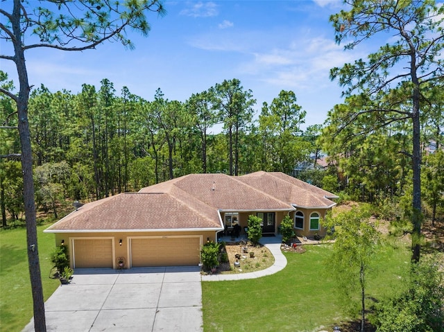 ranch-style home featuring concrete driveway, a garage, a front yard, and stucco siding