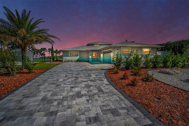 1620 Sea Breeze Dr, Tarpon Springs, FL 34689 - view of front of home featuring decorative driveway, a garage, and stucco siding