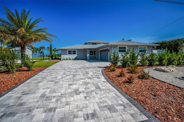 1620 Sea Breeze Dr, Tarpon Springs, FL 34689 - single story home featuring decorative driveway, stucco siding, and an attached garage