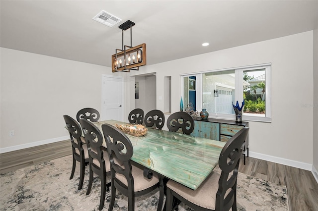 1620 Sea Breeze Dr, Tarpon Springs, FL 34689 - dining area with wood finished floors, a chandelier, baseboards, and recessed lighting