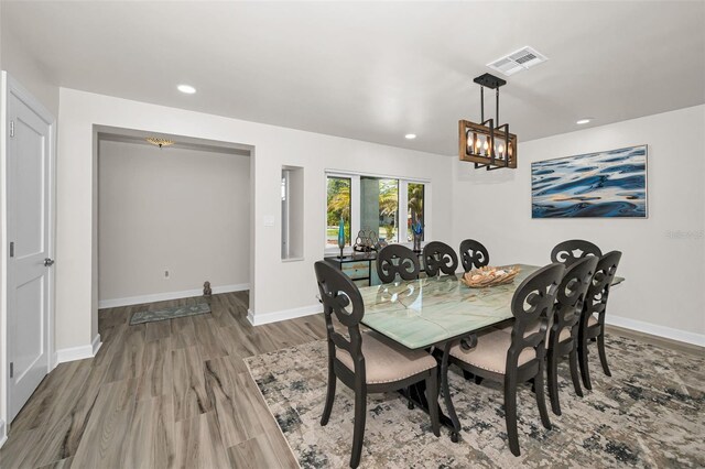 1620 Sea Breeze Dr, Tarpon Springs, FL 34689 - dining room featuring wood finished floors, recessed lighting, baseboards, and a chandelier