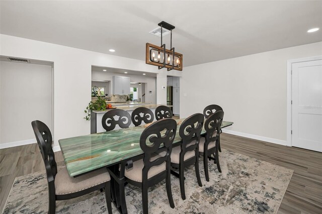 1620 Sea Breeze Dr, Tarpon Springs, FL 34689 - dining area featuring wood finished floors, a chandelier, baseboards, and recessed lighting