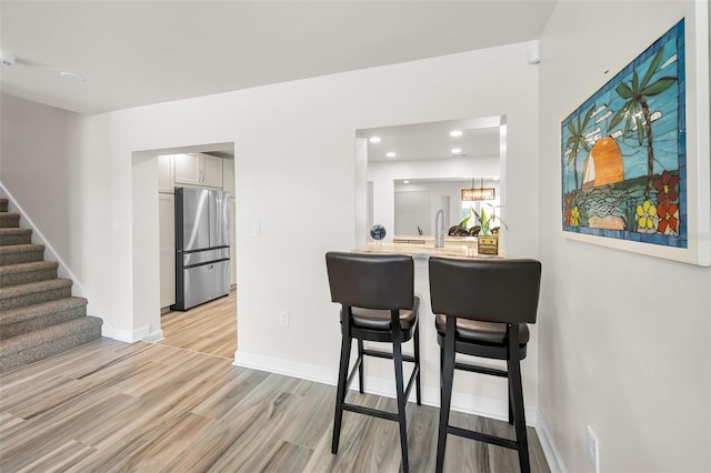 1620 Sea Breeze Dr, Tarpon Springs, FL 34689 - dining room with stairs, light wood-style flooring, baseboards, and recessed lighting