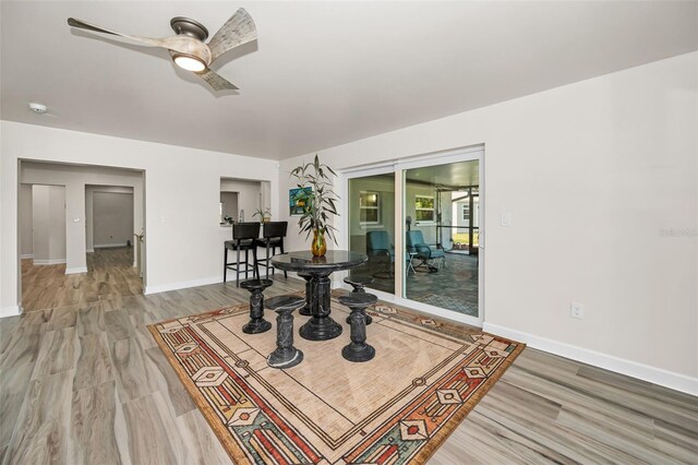 1620 Sea Breeze Dr, Tarpon Springs, FL 34689 - dining space with ceiling fan, baseboards, and light wood-style flooring