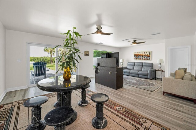 1620 Sea Breeze Dr, Tarpon Springs, FL 34689 - dining space with light wood-style flooring, ceiling fan, and baseboards