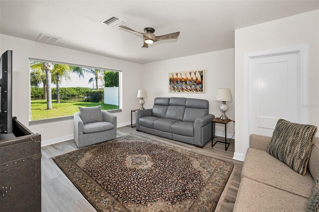 1620 Sea Breeze Dr, Tarpon Springs, FL 34689 - living room featuring baseboards, ceiling fan, and wood finished floors