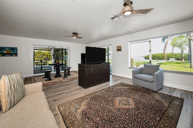 1620 Sea Breeze Dr, Tarpon Springs, FL 34689 - living area featuring a ceiling fan, wood finished floors, and baseboards