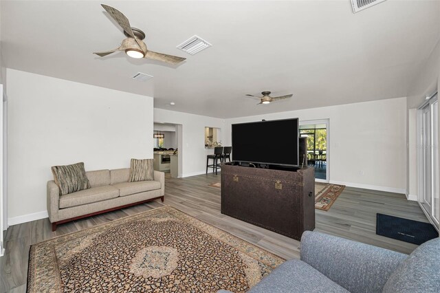 1620 Sea Breeze Dr, Tarpon Springs, FL 34689 - living area featuring ceiling fan, wood finished floors, and baseboards