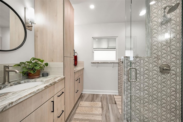 1620 Sea Breeze Dr, Tarpon Springs, FL 34689 - full bath with wood finished floors, a shower stall, vanity, baseboards, and recessed lighting
