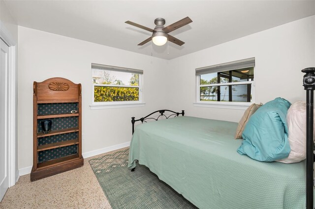 1620 Sea Breeze Dr, Tarpon Springs, FL 34689 - bedroom with speckled floor, baseboards, and a ceiling fan