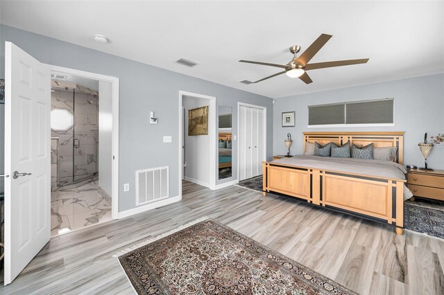 1620 Sea Breeze Dr, Tarpon Springs, FL 34689 - bedroom with baseboards, a ceiling fan, ensuite bath, and light wood-type flooring