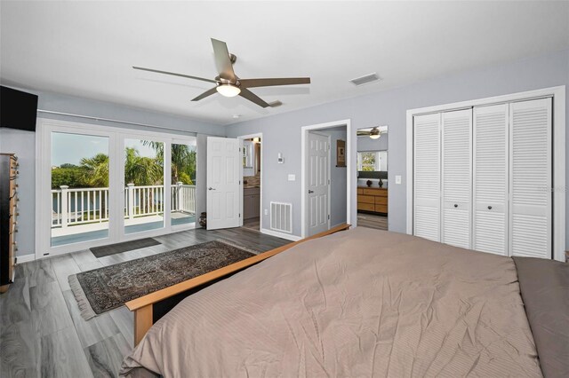 1620 Sea Breeze Dr, Tarpon Springs, FL 34689 - bedroom featuring access to exterior, multiple windows, baseboards, and connected bathroom