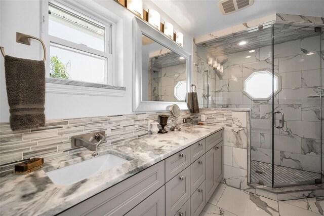 1620 Sea Breeze Dr, Tarpon Springs, FL 34689 - bathroom featuring marble finish floors, double vanity, healthy amount of natural light, and decorative backsplash