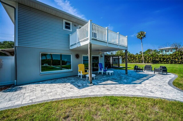 1620 Sea Breeze Dr, Tarpon Springs, FL 34689 - rear view of house with a balcony, a lawn, a patio, and stucco siding