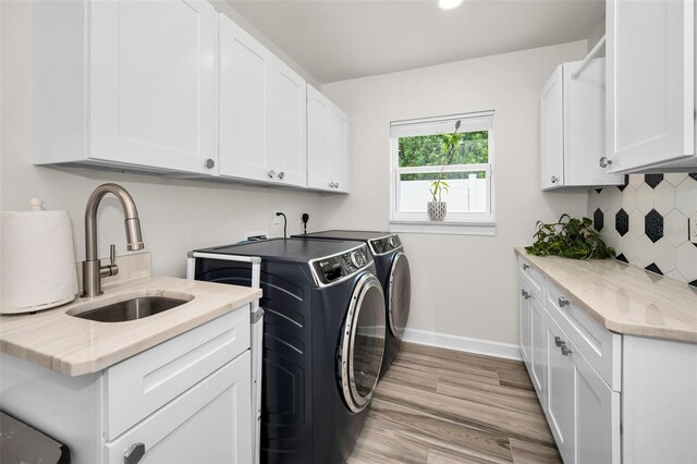 1620 Sea Breeze Dr, Tarpon Springs, FL 34689 - washroom with separate washer and dryer, cabinet space, light wood finished floors, baseboards, and recessed lighting