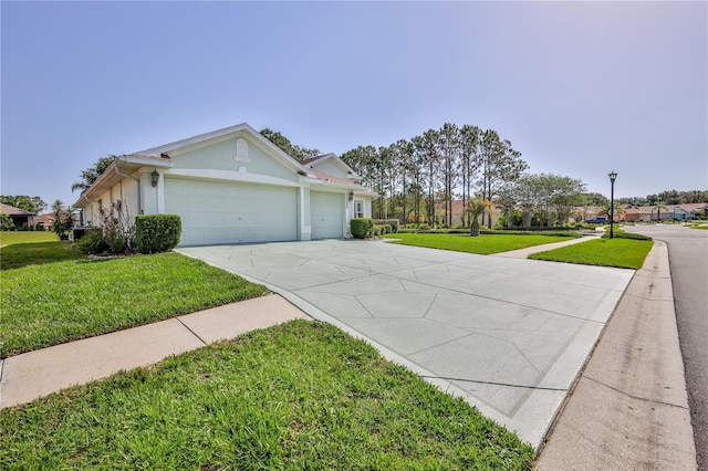 view of front of house with concrete driveway, an attached garage, a front lawn, and stucco siding