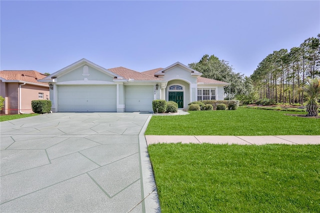 ranch-style house with a garage, concrete driveway, stucco siding, and a front yard