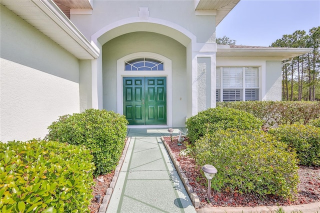 property entrance with stucco siding