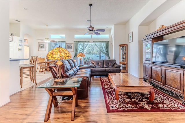 living area featuring light wood-style floors and a ceiling fan