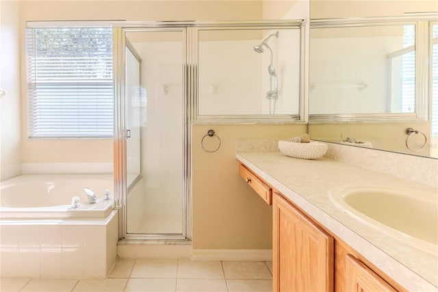 full bathroom with a garden tub, a shower stall, vanity, and tile patterned flooring