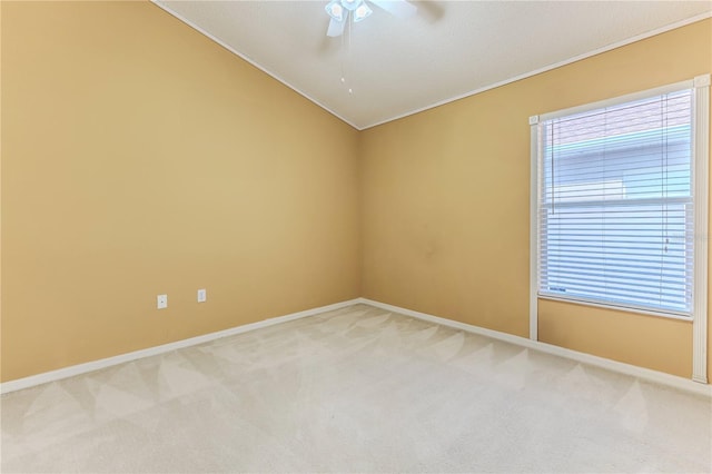 empty room featuring light carpet, ceiling fan, baseboards, and ornamental molding