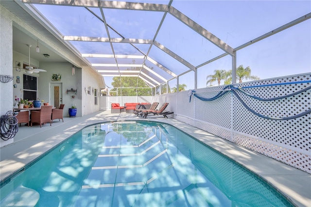 view of pool featuring an outdoor hangout area, a patio, ceiling fan, a lanai, and outdoor dining area