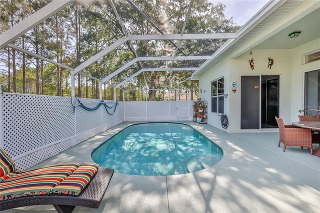 view of pool featuring a patio area and glass enclosure