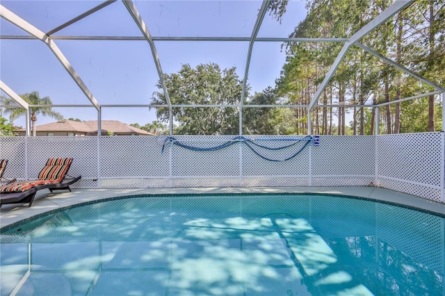 view of swimming pool featuring a lanai and a patio area